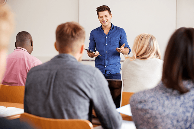 male TEFL teacher leading business English lesson