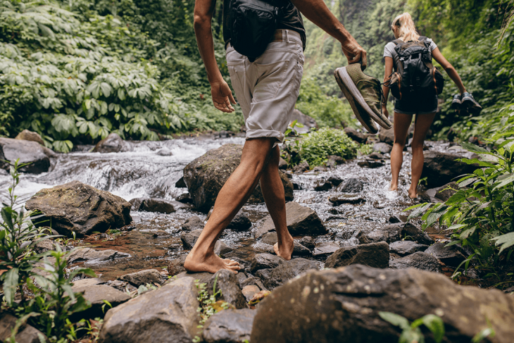 travellers hiking by waterfalls