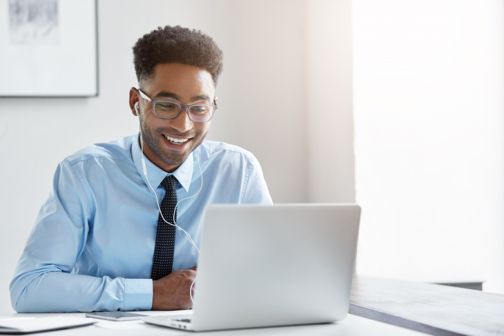 man on laptop teaching online