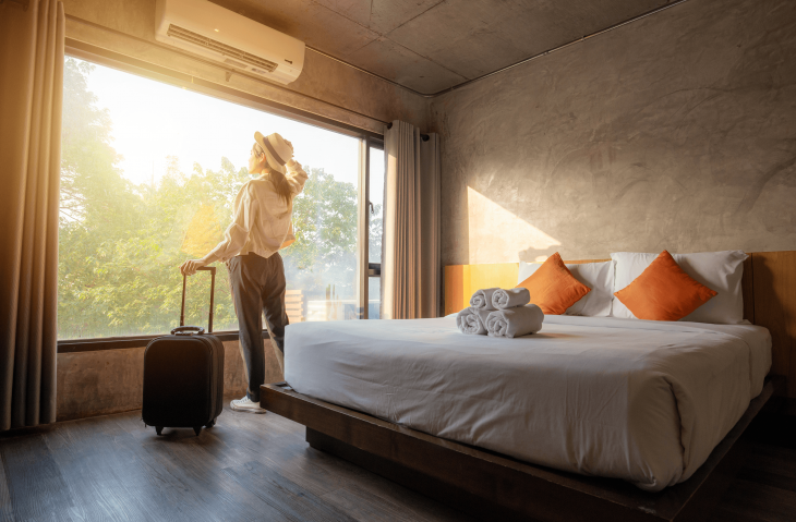 traveler in hotel room with wifi where she can work on her online TEFL certification course