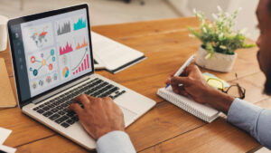 recruiter at laptop taking notes on recruitment metrics best practices