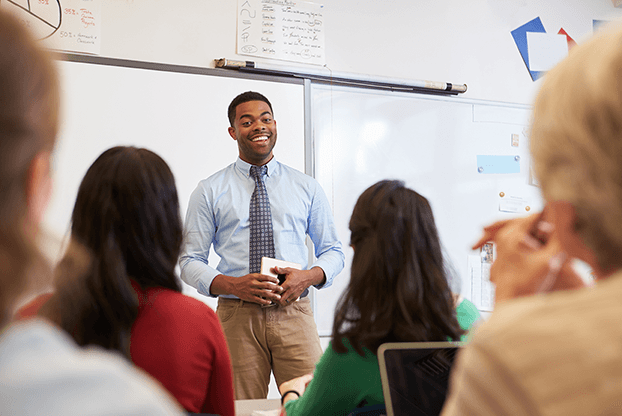 male teacher leading business English lesson in classroom