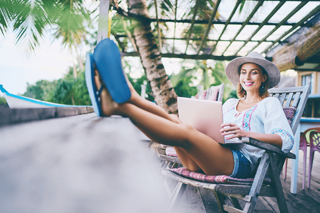 woman working on laptop in tropical location