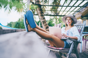 woman working on laptop in tropical location