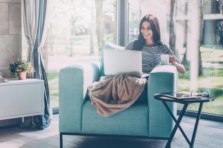 woman on laptop on couch - productive things to do at home during covid-19