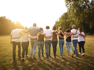 group standing in field together - Teach Away COVID-19