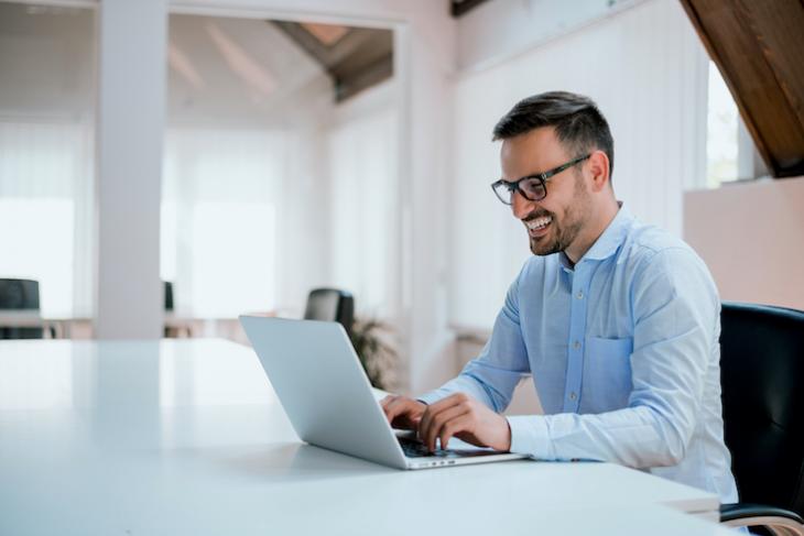 man sitting at computer - candidate pool