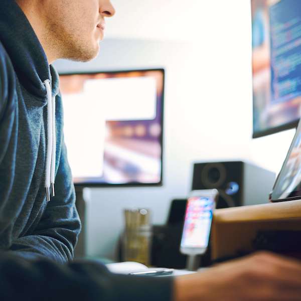 man at a computer learning how to get a teaching license
