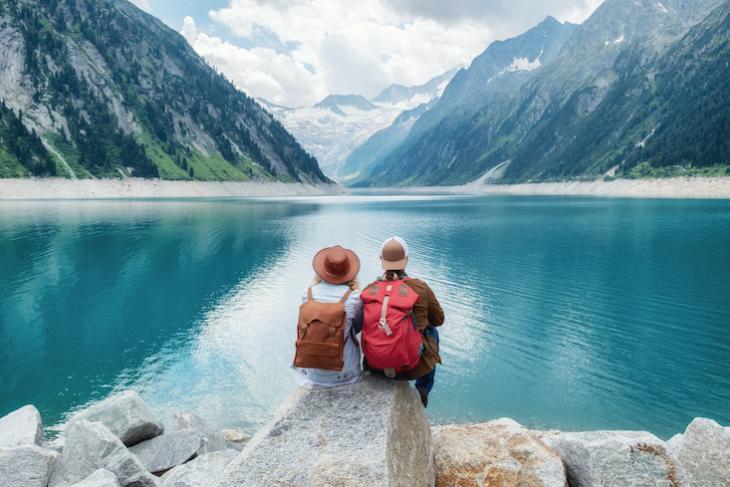 couple sitting by mountains - how to teach in a different country
