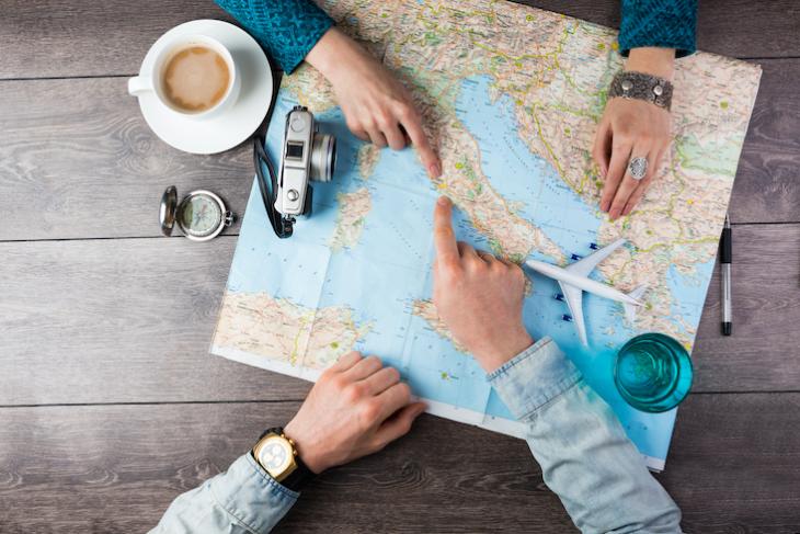 couple pointing to a map - how to teach in a different country