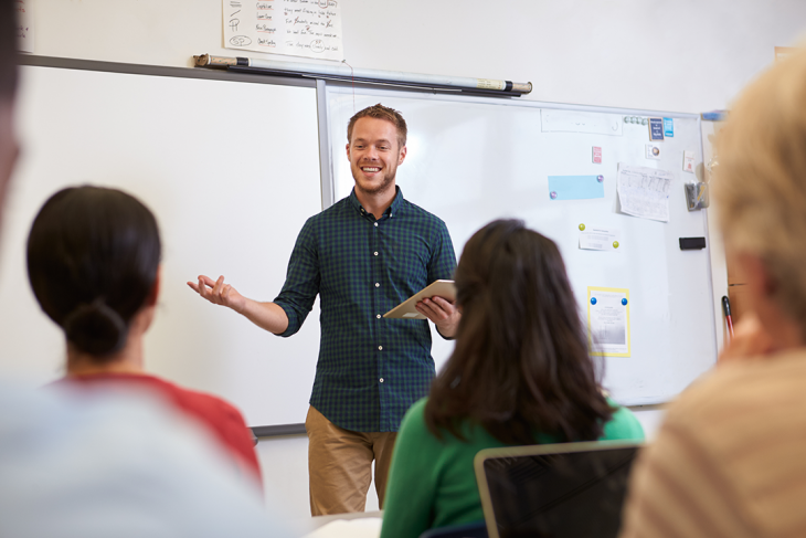Photo of young male TEFL teacher in front of class - best online TEFL courses.