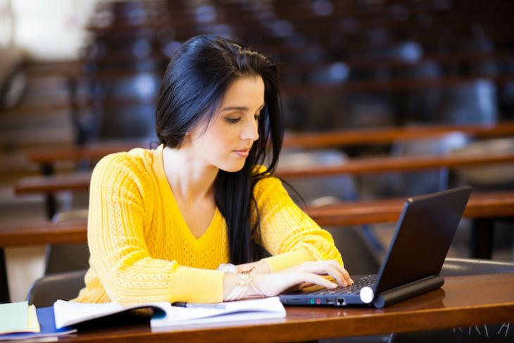 woman studying on her laptop - teaching after college. 