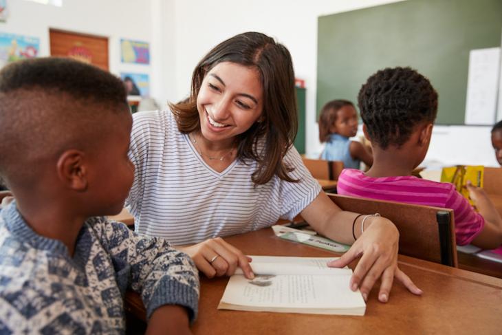 teacher helping student - teaching after college. 