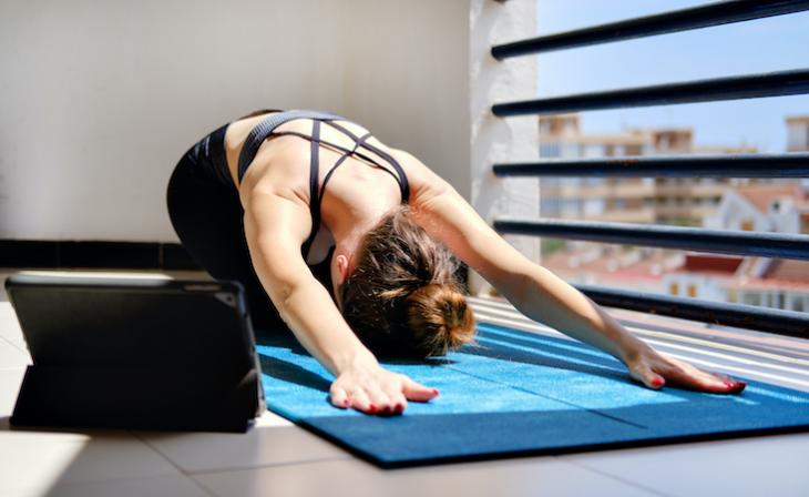 woman doing yoga in her living room.