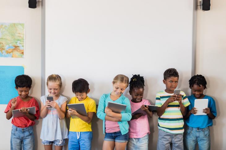 Children using technology in an ESL classroom.