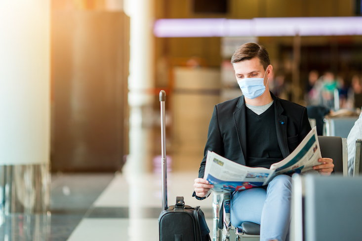 Photo of man at the airport with mask on.