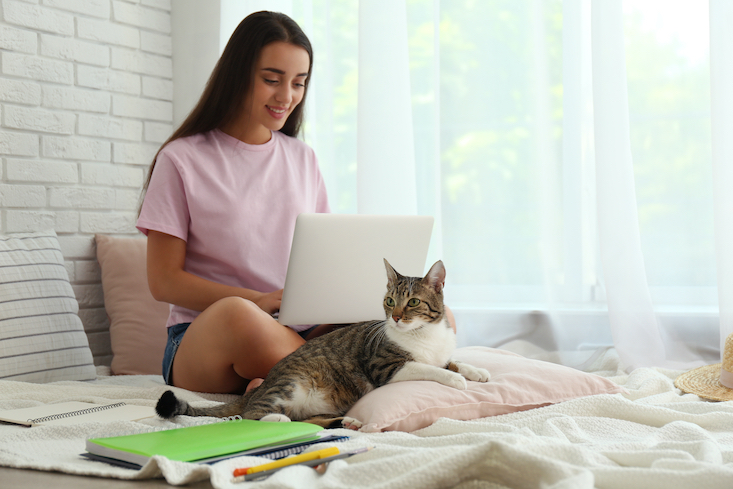 Woman researching "why teach English online" on laptop.