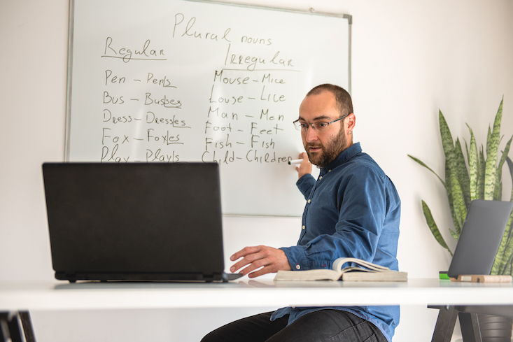 Man looking up online if you need TEFL to teach English online.