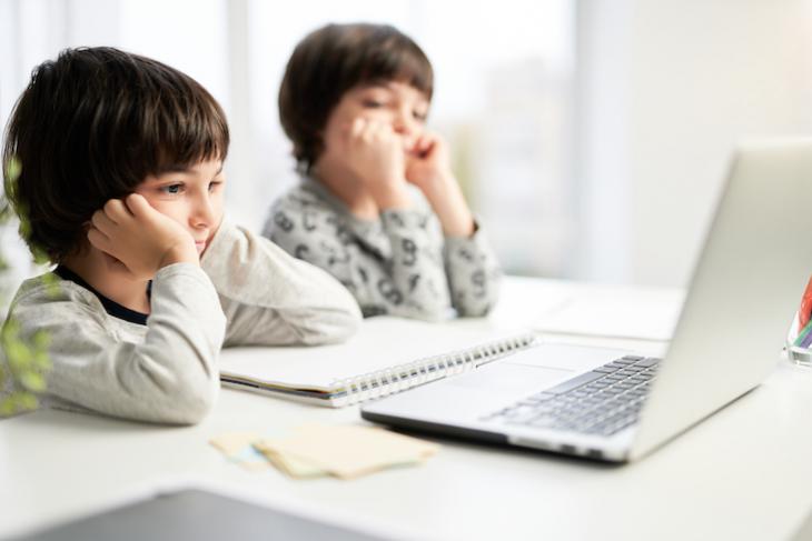 Photo of students online with teacher teaching kids English online.