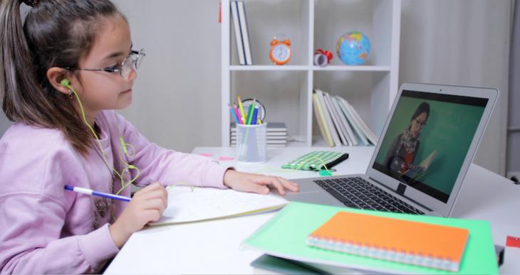 Photo of woman teaching kids English online.