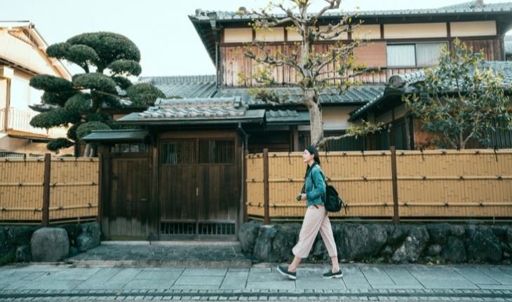woman walking down a residential street in japan