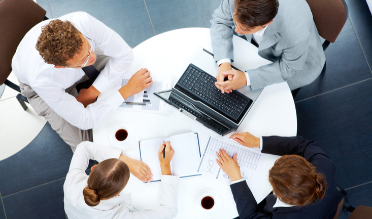 human resources professionals sharing notes and resources at a table
