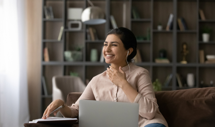 woman sitting on a couch teaching english online for why you should get tefl certified with teach away article