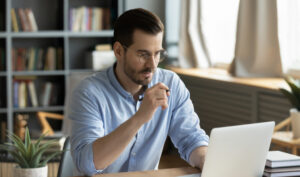 man at laptop filling out an application online