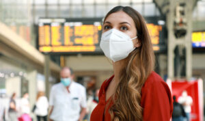 woman wearing n95 mask in an airport