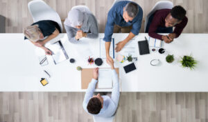 Diverse international recruiters at a desk interviewing a candidate