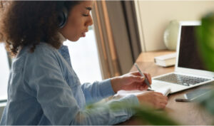 woman at a desk in front of a laptop for china's new private tutoring regulations article