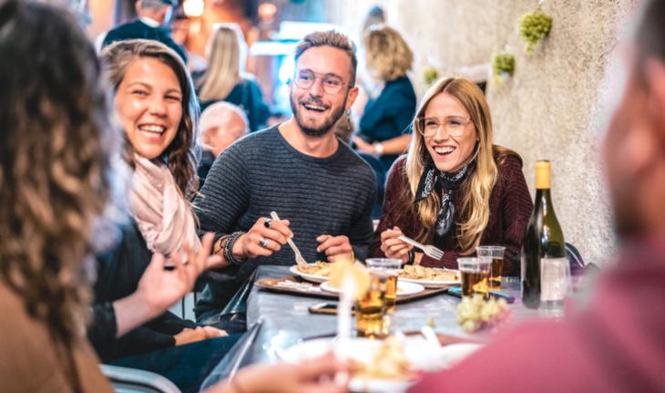 friends traveling and eating with locals