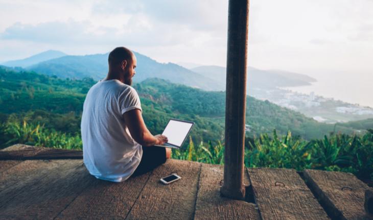 man on lap looking out at rainforest jungle scenery