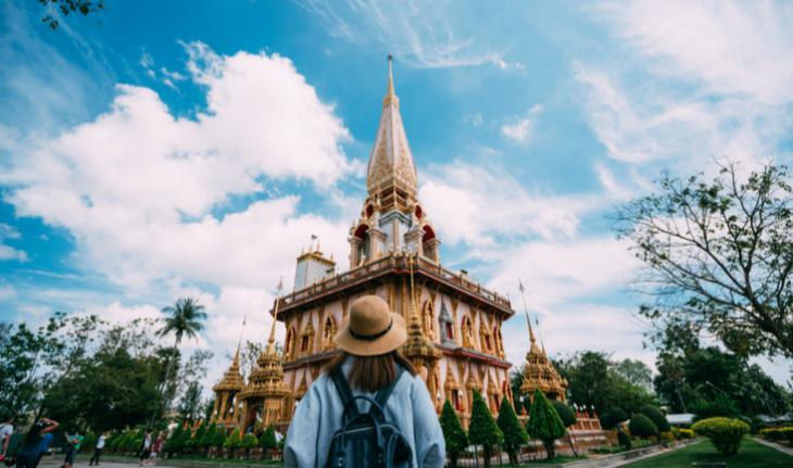 woman tourist in malaysia standing in front of a pagoda