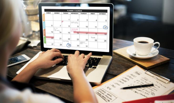 woman at a laptop planning her day with a teaching app