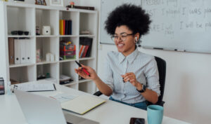 woman teaching english online in front of a laptop