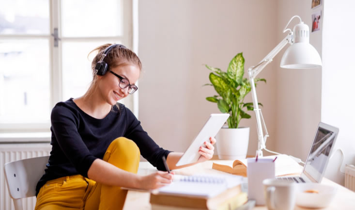 woman sitting on a chair teaching english online. how to get started teaching english online