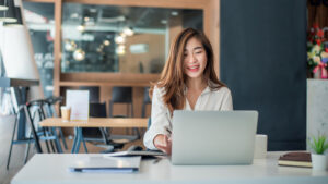 woman sitting a laptop for why teach english as a second language article