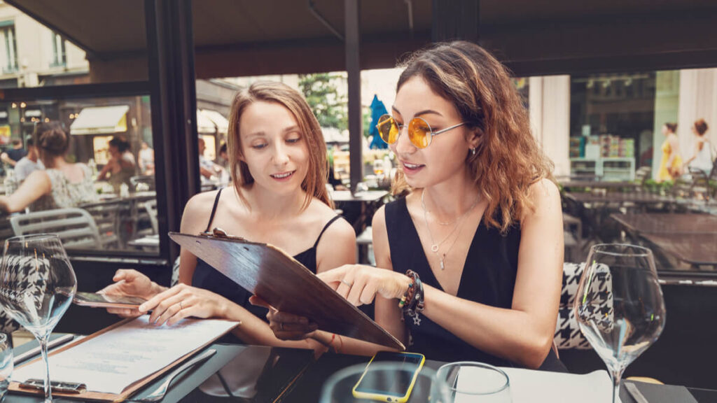 two people ordering food from a menu as a homework idea for english language learners