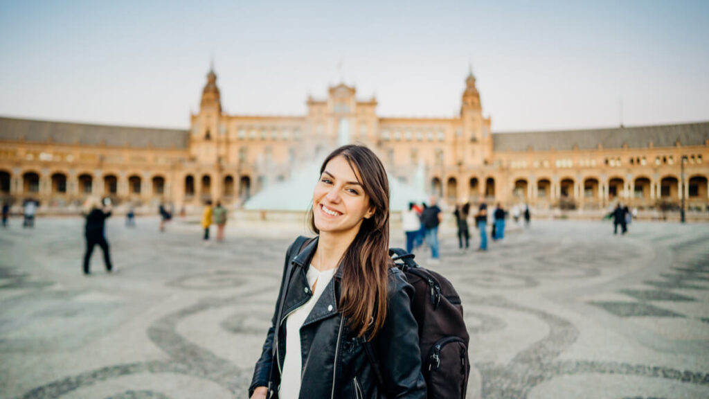 new esl teacher standing in front of plaza de espana in seville, spain teaching english in spain