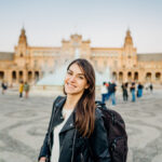 new esl teacher standing in front of plaza de espana in seville, spain teaching english in spain