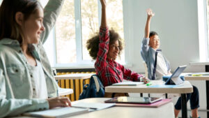 happy middle school students raising their hands are a sign of great teacher stories