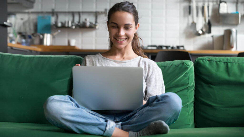 bachelor of education graduate looking on laptop for online teaching jobs