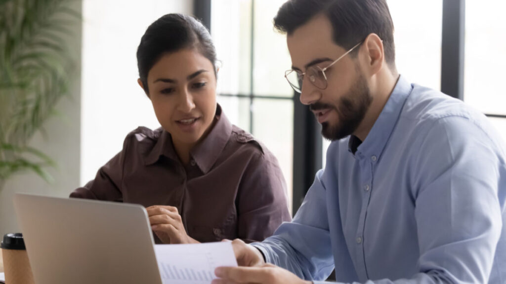 two colleagues discussing salary transparency in teacher job postings