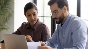 two colleagues discussing salary transparency in teacher job postings