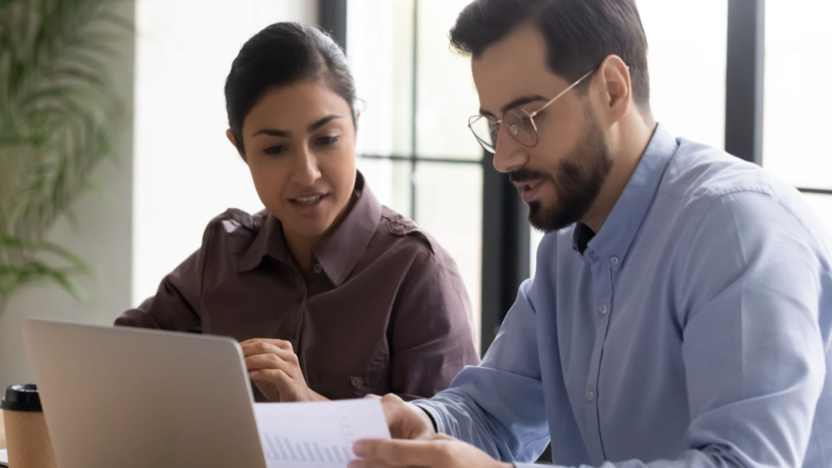 two colleagues discussing salary transparency in teacher job postings
