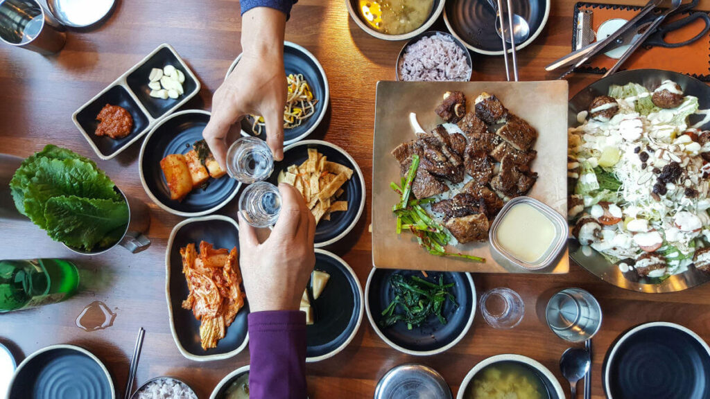 friends practicing table manners and etiquette in korea