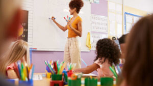 teacher in front of a classroom for world teachers day