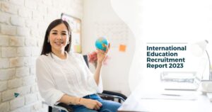 international recruiter sitting at desk applying teacher recruitment strategies from the international education recruitment report 2023 from teach away
