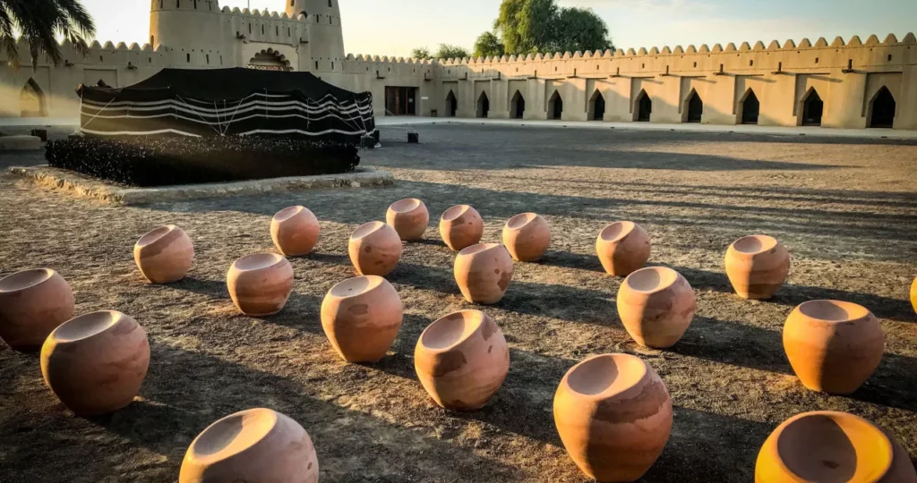teach in al ain uae to witness the marvels of al jahili fort pictured here at dusk with clusters of water clay water pots in the foreground